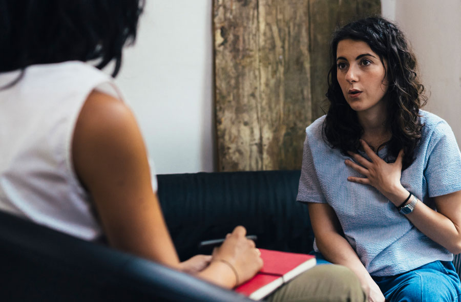 Image of a young woman speaking with a therapist